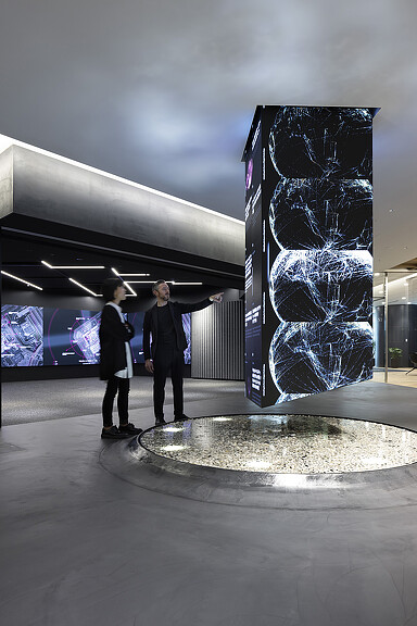 A couple of men standing in front of a large sculpture.